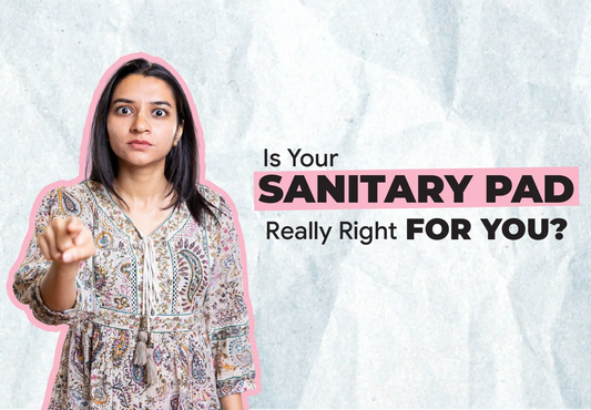 Woman checking sanitary pad label - signs your conventional pad is causing rashes, cramps and infections